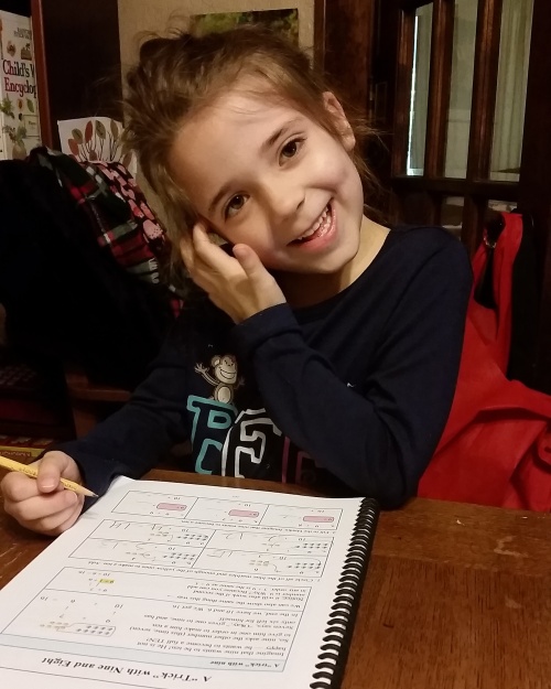 a girl enjoying Math Mammoth 1st grade worksheet