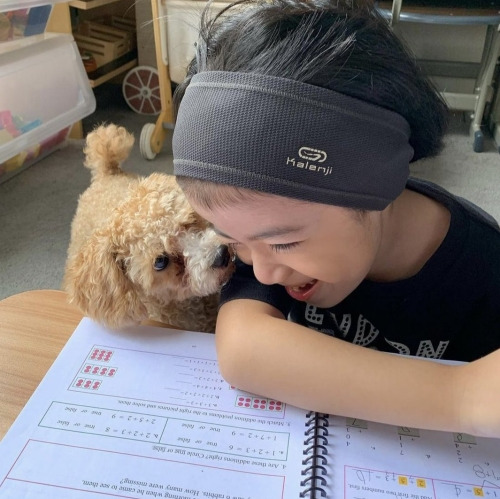 Girl and dog doing math