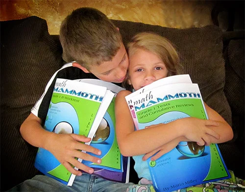 Children hugging Math Mammoth books