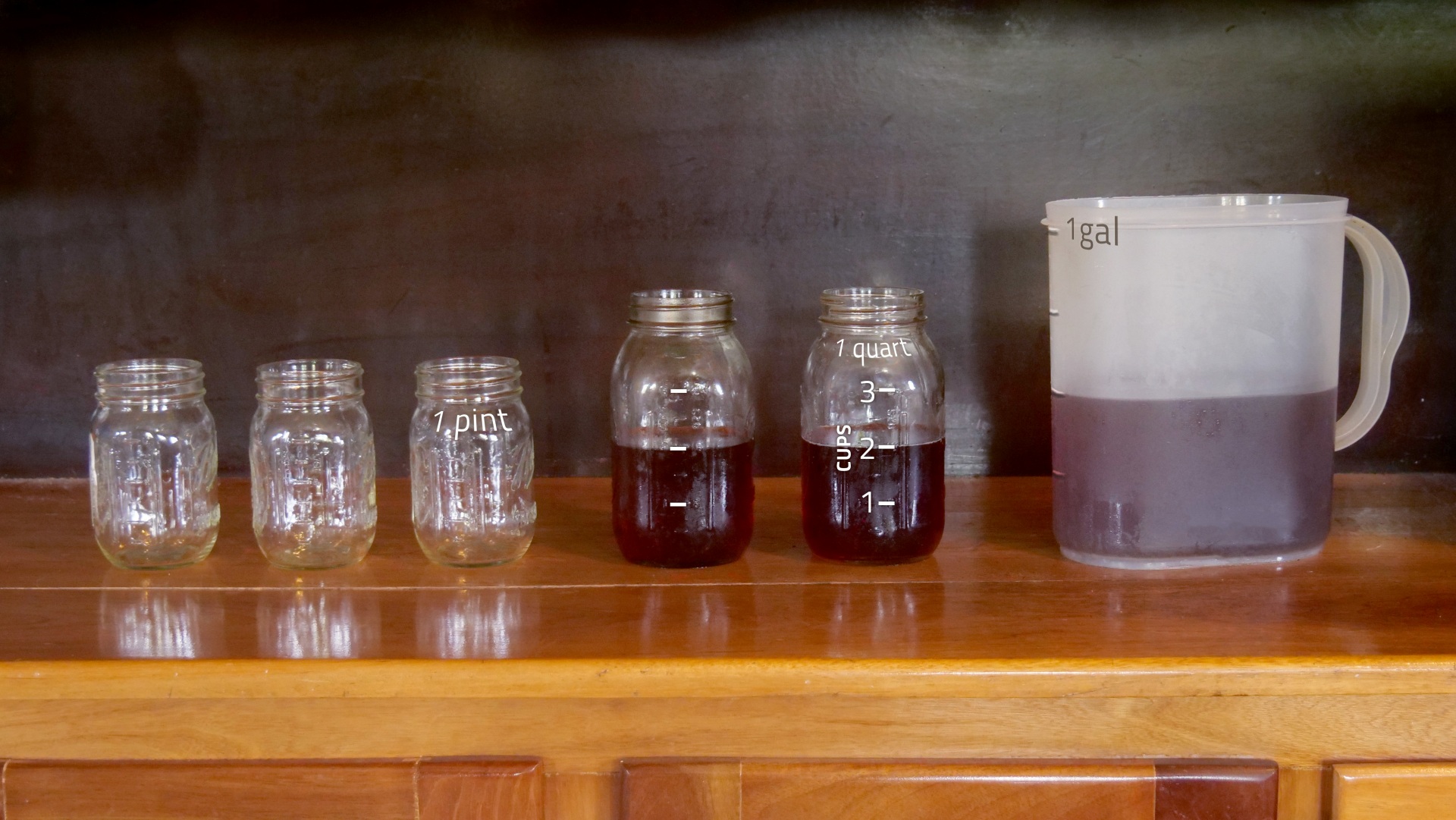 half-full 1-gallon pitcher, two 1-qt jars and three 1-pt jars