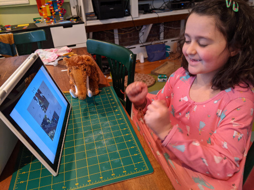 Girl enjoying a hidden picture math game online