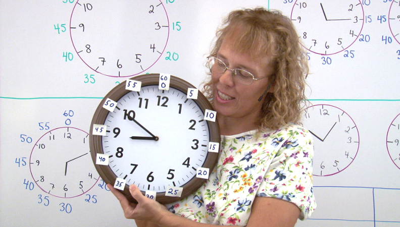 Me holding a clock with stickers for the minute amounts